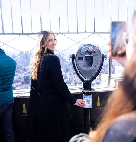 Woman getting her photo taken on the 86th Floor of the Empire State Building Observatory